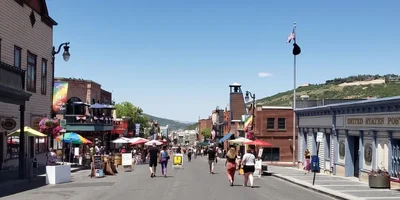 Historic Main Street Park City during a summer evening event with string lights and outdoor dining