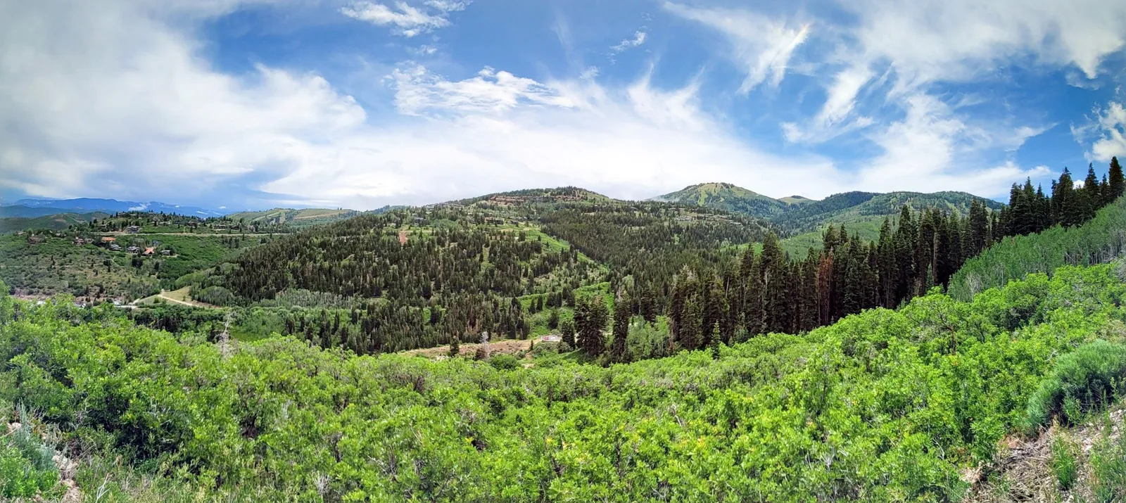 Panoramic view of Park City Utah mountains and luxury homes, showcasing the landscape and lifestyle marketed by Real Estate in Park City when selling high-end properties.
