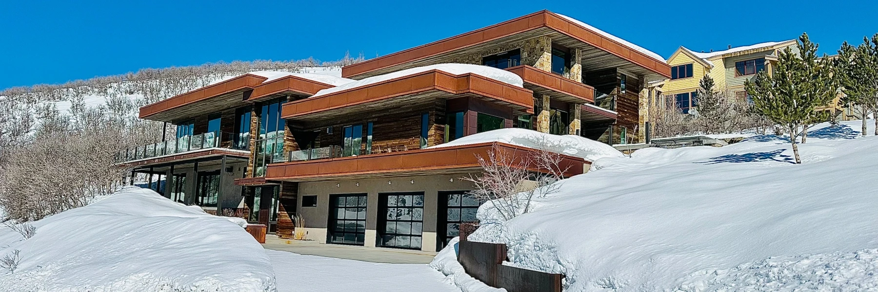Modern luxury home in the Aerie neighborhood of Park City, Utah, surrounded by winter snow
