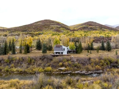 Riverfront home in Oakley Utah surrounded by fall colors with mountain views and open landscape