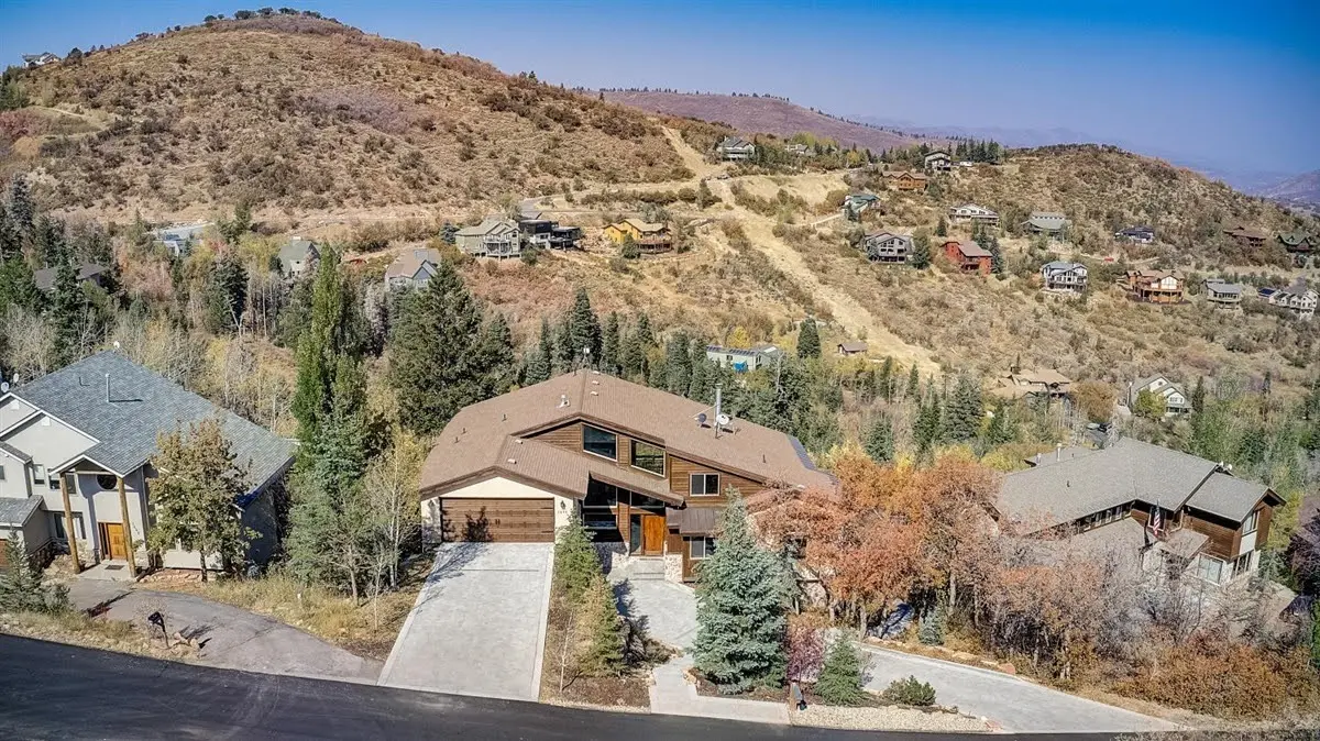 Aerial view of Pinebrook neighborhood in Park City Utah showing wooded hillside homes surrounded by pine and aspen trees