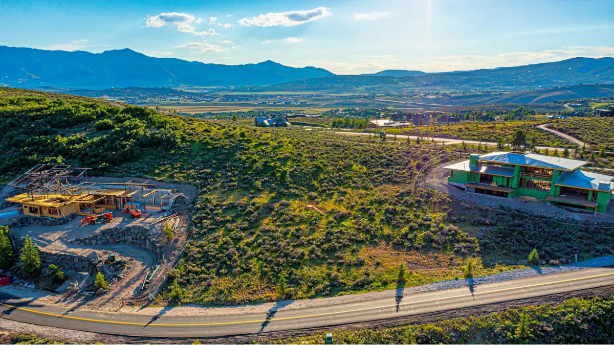 Aerial view of Promontory Park City lots and neighborhoods with golf courses and mountain backdrop