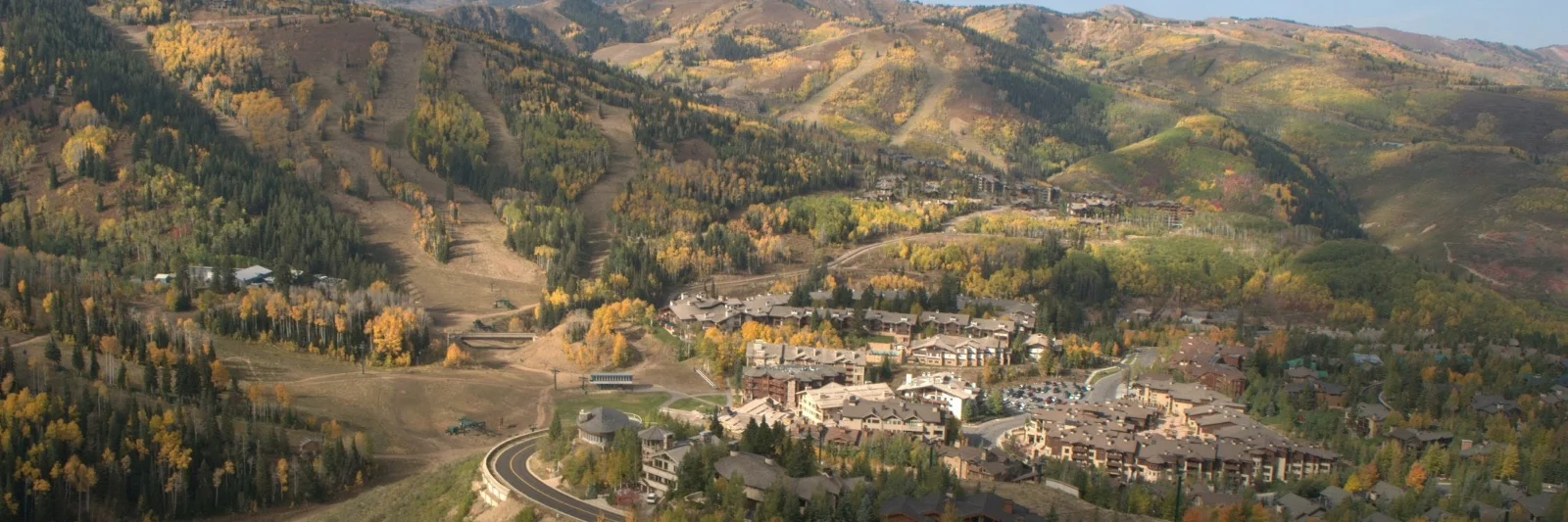 Aerial view of Upper Deer Valley condos surrounded by ski runs and fall foliage in Park City, Utah